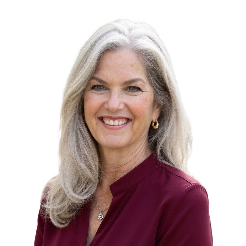 Smiling gray-haired woman in maroon blouse